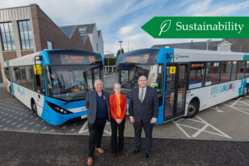 Two Stagecoach buses with three people standing in front of them, two university staff members and a Stagecoach representative